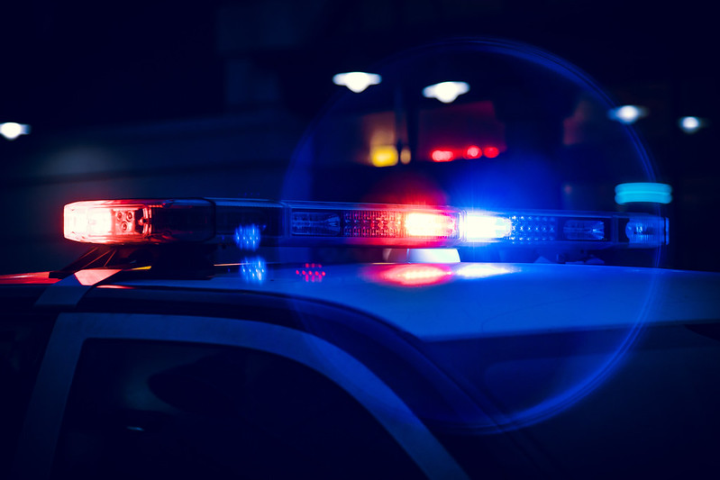 Police vehicle with sirens on